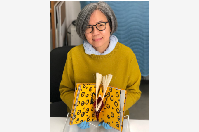 Tina Tan, conservator, works on paper